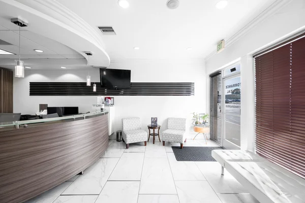 The front entrance of Torrance Dental Center. There is a small sitting area beside the door.