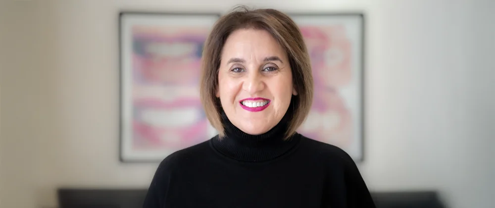 Dentist Torrance CA Sharareh Khoshbin A professional photo of dentist Sharareh Khoshbin, smiling and wearing a turtleneck sweater